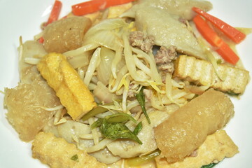 fried bean sprout with slice yellow tofu and chop pork couple fish ball on plate