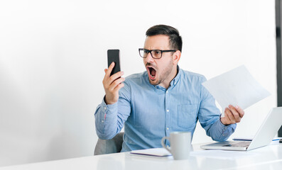 Angry disagreeable businessman sitting at the desk talking online video conference call making unpleasant discussion arguing confronting opinion decision or idea unsatisfied results deadline shouting