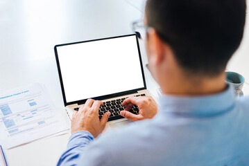 Over the shoulder view of blank mock-up white empty screen businessman entrepreneur looking at laptop computer screen hands over keyboard video conference call meeting working from home lock downcopy