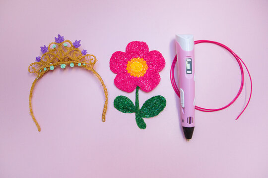3d printing pen. The flower and the crown are made using a pen for 3D printing. 
On a pink background.