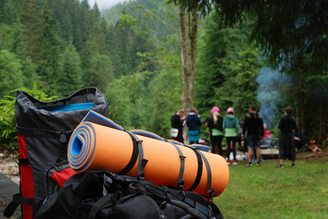 Travel backpack and mat outdoors. Camping in the mountains. Sports equipment for tourism and...
