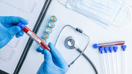 Omicron mutation coronavirus variant. Medical laboratory doctor holding test tube in hospital...