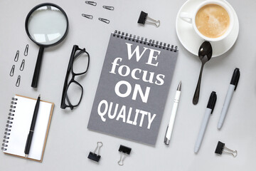 We focus on quality. notepad on gray background with text