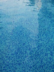 blue tiles of a swimming pool