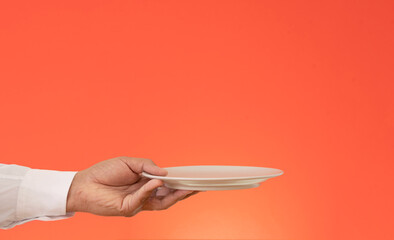 Close up photo of waiter holding empty plate for product advertisement  mock up.