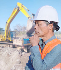 A middle-aged construction engineer on a construction site, an Asian senior.