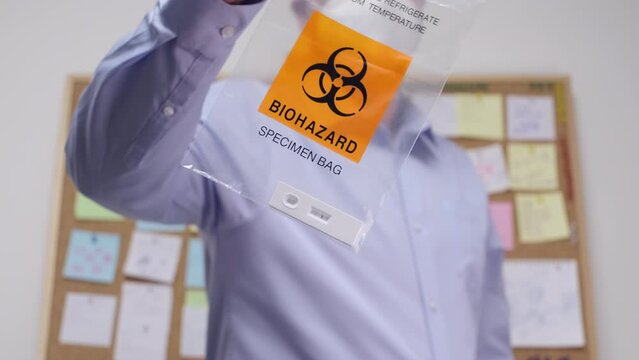 Office Worker showing Biohazard Specimen Bag with Positive PCR Antigen Test, Busy timeline and sick leave Business during pandemic concept.