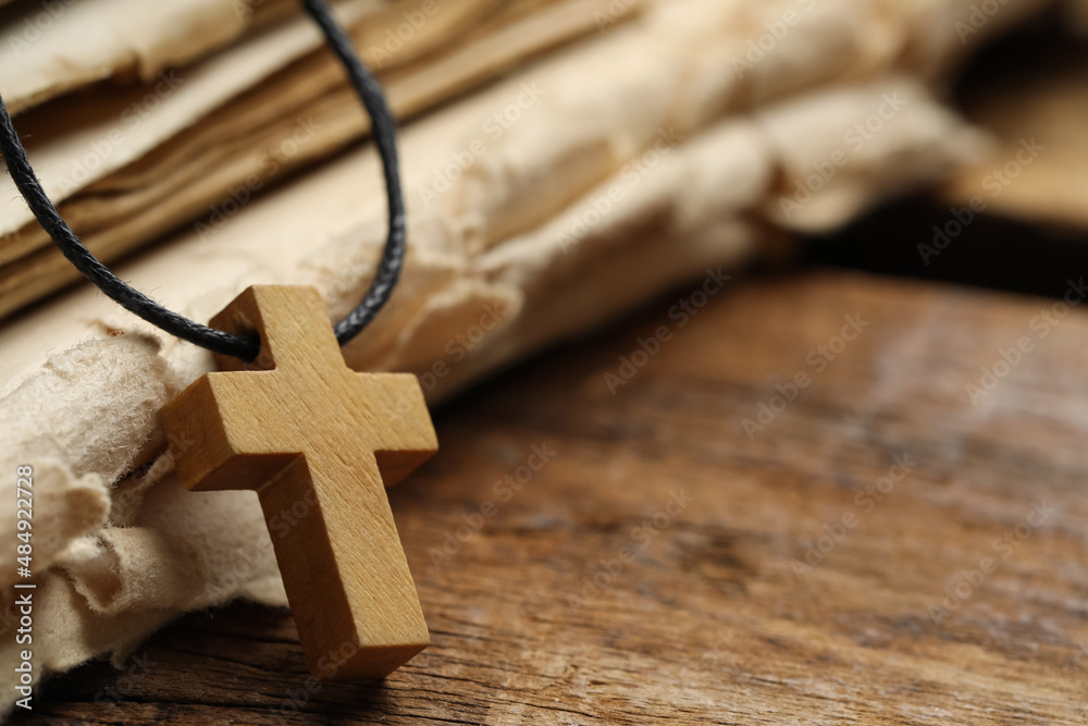 Wall mural wooden christian cross and old bible on table, closeup. space for text