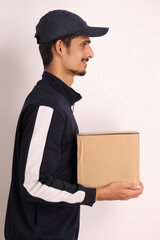 unshaven Indian courier boy with brown box wearing black t-shirt with facial expressions isolated on white background 