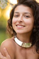 Portrait of a young sexy brunette girl with a necklace around her neck