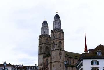 Fototapeta na wymiar Protestant church Great Minster at the old town of Zürich with gray sky background on a winter day. Photo taken February 1st, 2022, Zurich, Switzerland.
