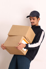 unshaven Indian courier boy with brown box wearing black t-shirt with facial expressions isolated on white background 