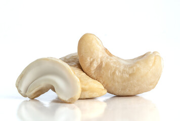 Macro photo of raw cashews on isolated white background.