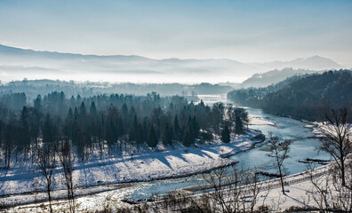 The view over the snowy mid-December landscape from the city walls of Belluno, in Veneto, north...