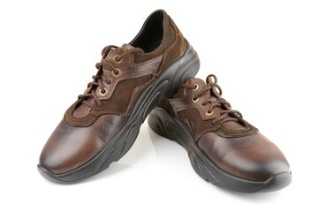Pair of brown leather shoes on white