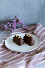 Chocolate brownie cakes with walnuts in chocolate. Chocolate cake on pink background. Luxury food concept. 