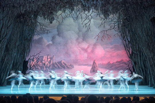 Classical ballet on stage of Theater. Ballet dancers on stage dance classical works. Form of artistic ball dance on stage of theater.