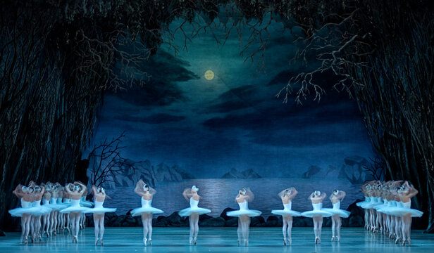 Classical ballet on stage of Theater. Ballet dancers on stage dance classical works. Form of artistic ball dance on stage of theater.
