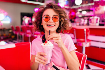 stylish smiling woman in retro vintage cafe