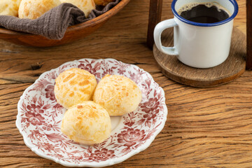 Typical brazilian cheese bun on a plate, coffee and jam