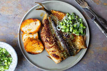 Butterflied mackerel fried with spicy butter with cucumber salsa