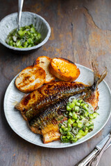 Butterflied mackerel fried with spicy butter with cucumber salsa
