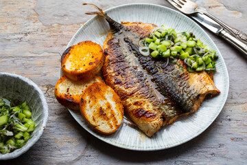 Butterflied mackerel fried with spicy butter with cucumber salsa