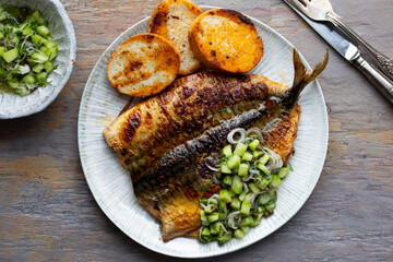 Butterflied mackerel fried with spicy butter with cucumber salsa