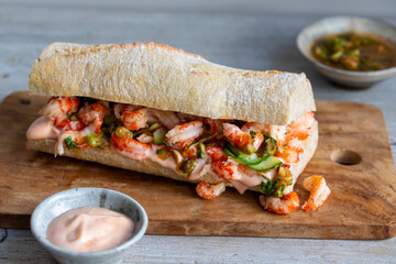 Stonebaked baquette with crayfish, pickled cucumbers, spicy dressing and sriracha mayonnaise