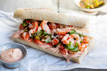 Stonebaked baquette with crayfish, pickled cucumbers, spicy dressing and sriracha mayonnaise
