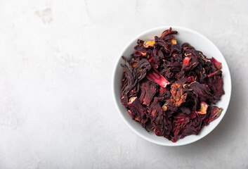 Hibiscus tea. Hibiscus tea in a white ceramic bowl on a gray cement background.Vitamin tea for colds and flu.Copy space.