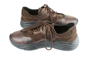 Pair of brown leather walking shoes on white