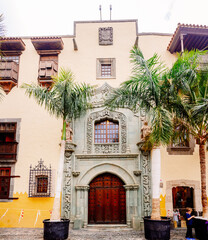 Facade of the Columbus house museum in Las Palmas de Gran Canaria, with its stone arch and beautiful wooden door.