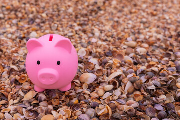 Pink piggy bank on the beach. Vacation savings concept. Place for text.