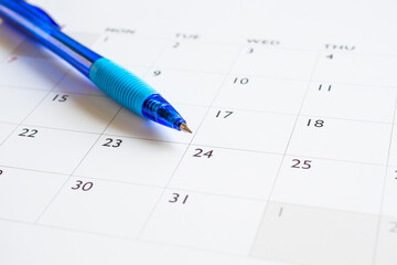 Blue pen on calendar page background business planning appointment meeting concept