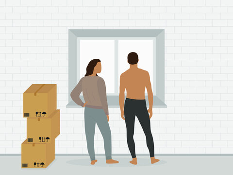 A male character and a female character in home clothes are standing near the window next to the cardboard boxes