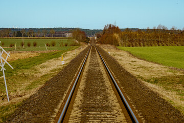 Fototapeta na wymiar The railway track in the autumn season, the driver's perspective 