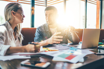 Creative young coworkers in cafe