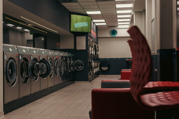 Laundromat inside in the evening, washing machines in a laundromat