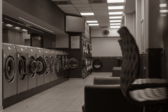Laundromat inside in the evening, washing machines in a laundromat, black and white photo - Powered by Adobe