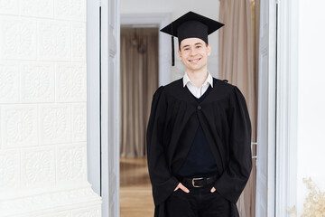 Education, graduation and people concept - happy male student with diploma at home showing his emotions