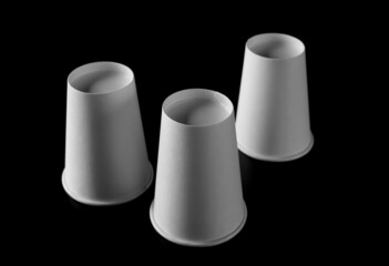 Disposable empty paper cups isolated on black background, clipping path