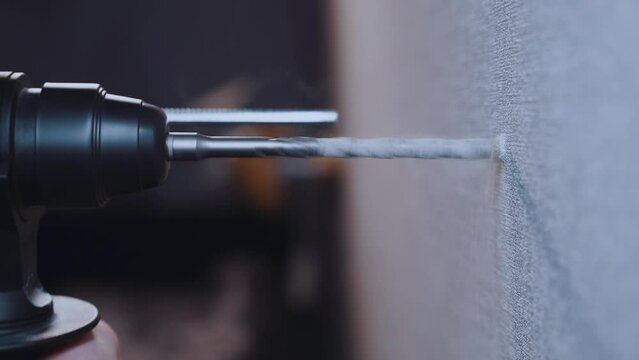 Close-up of the drill drill on concrete, the drill goes into the wall
