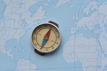 compass on the background of a contour map. journey. geography. north-south concept