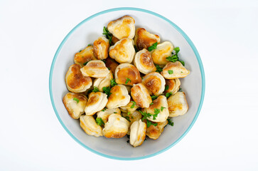 Blue bowl with fried dumplings. Studio Photo