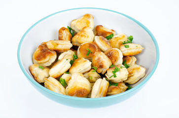 Blue bowl with fried dumplings. Studio Photo