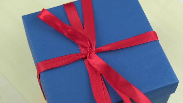 Close up rotating footage of blue gift box.