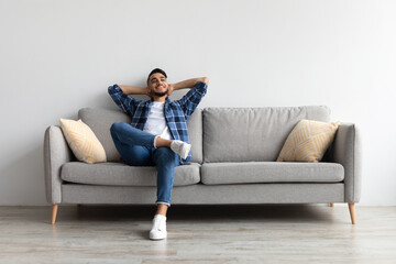Man having rest at home on the couch - obrazy, fototapety, plakaty