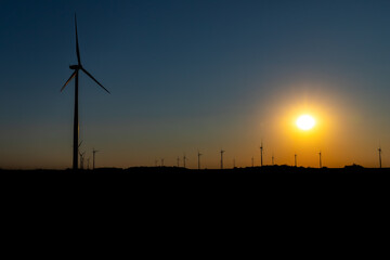 Fototapeta premium Wind Turbines Farm At sunset