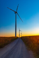 Obraz premium Wind Turbines Farm At sunset